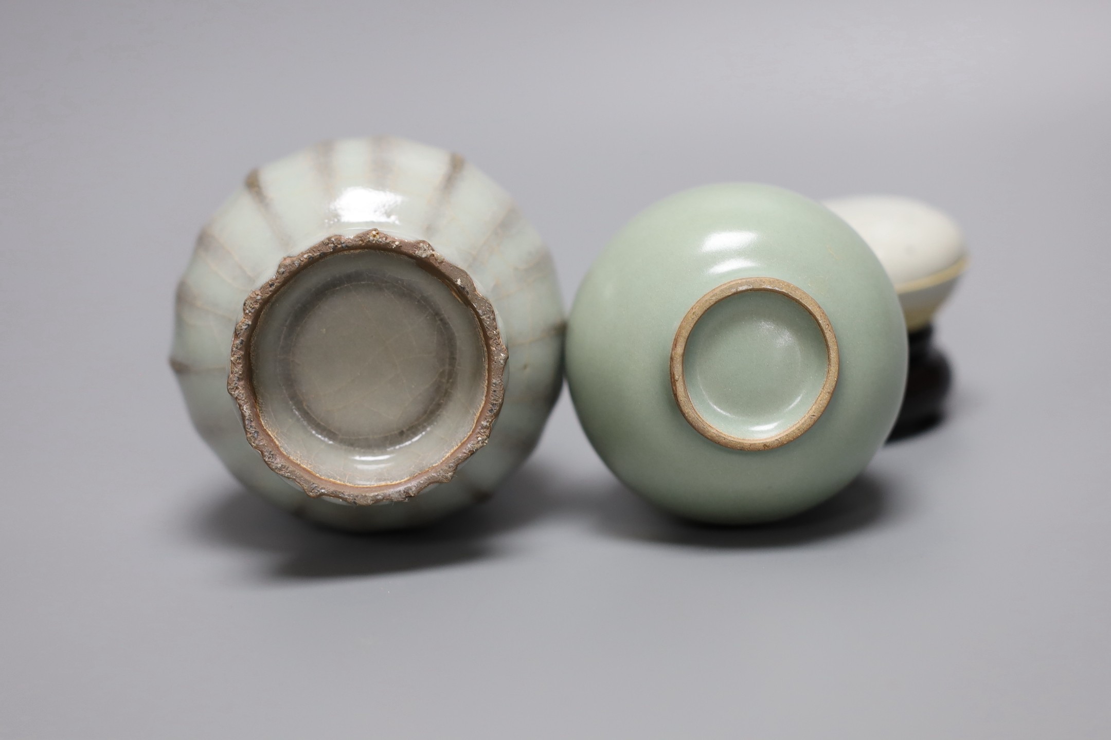 A Chinese celadon ground bottle vase, a similar crackle glazed vase, a paste box with cover and stand, tallest 16cm